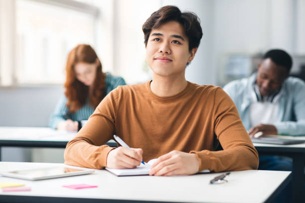 Student studying with laptop and notes